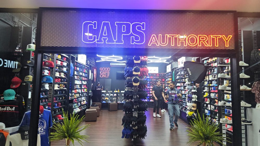 Entrada de la tienda con exhibidores de gorras